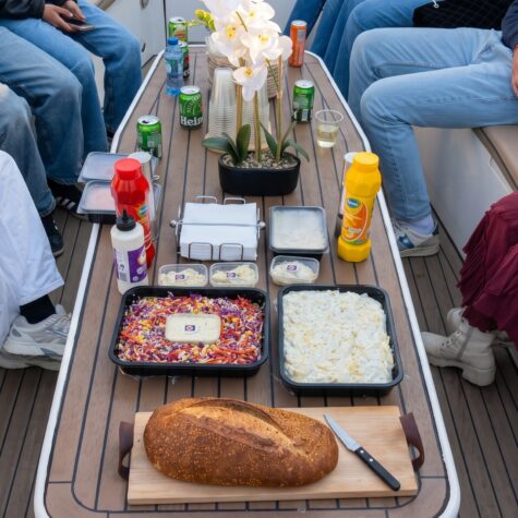 A top down image of condiments and salads included on the bbq boat